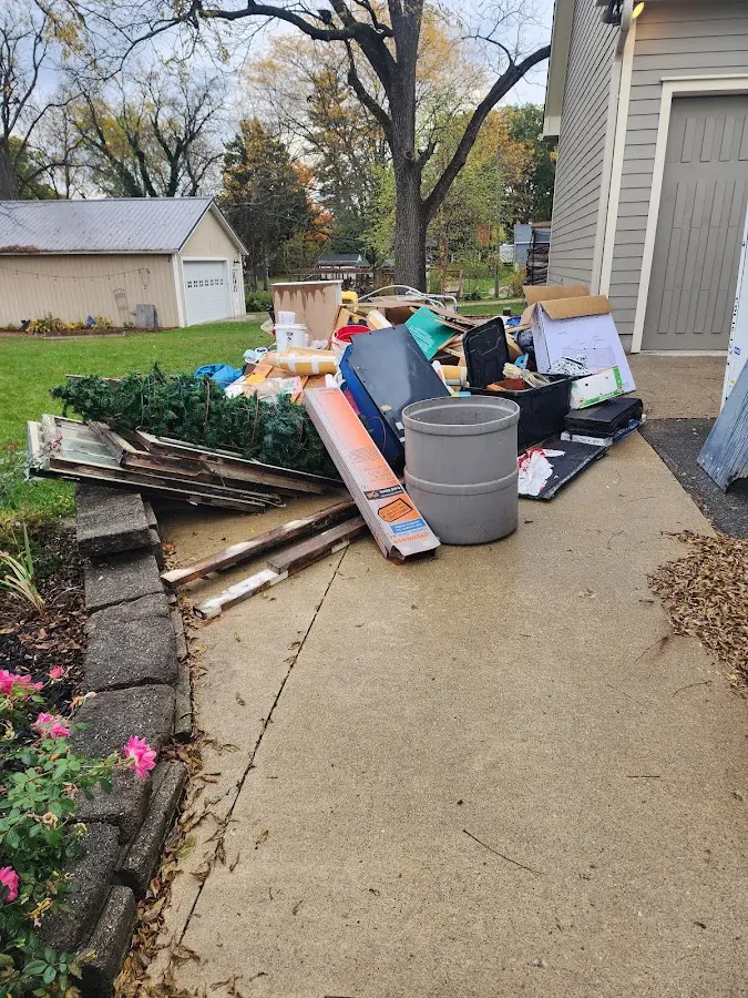 Dumpster being loaded with debris for Estate Cleanout Dumpster Rental in Channahon